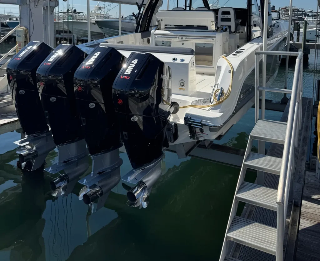 Boston Whaler with four Mercury V10 outboards on a boat lift at a Miami marina