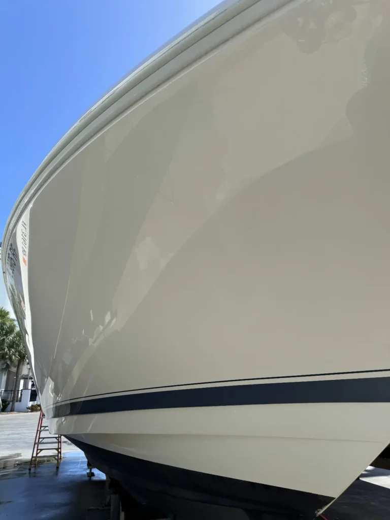 White gelcoat bow of a center console boat with a glossy, reflective finish in Miami